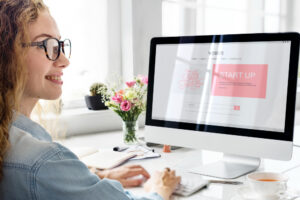 Photo of a young woman working on computor.