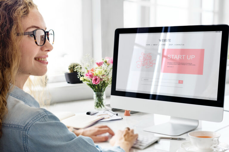 Photo of a young woman working on computor.